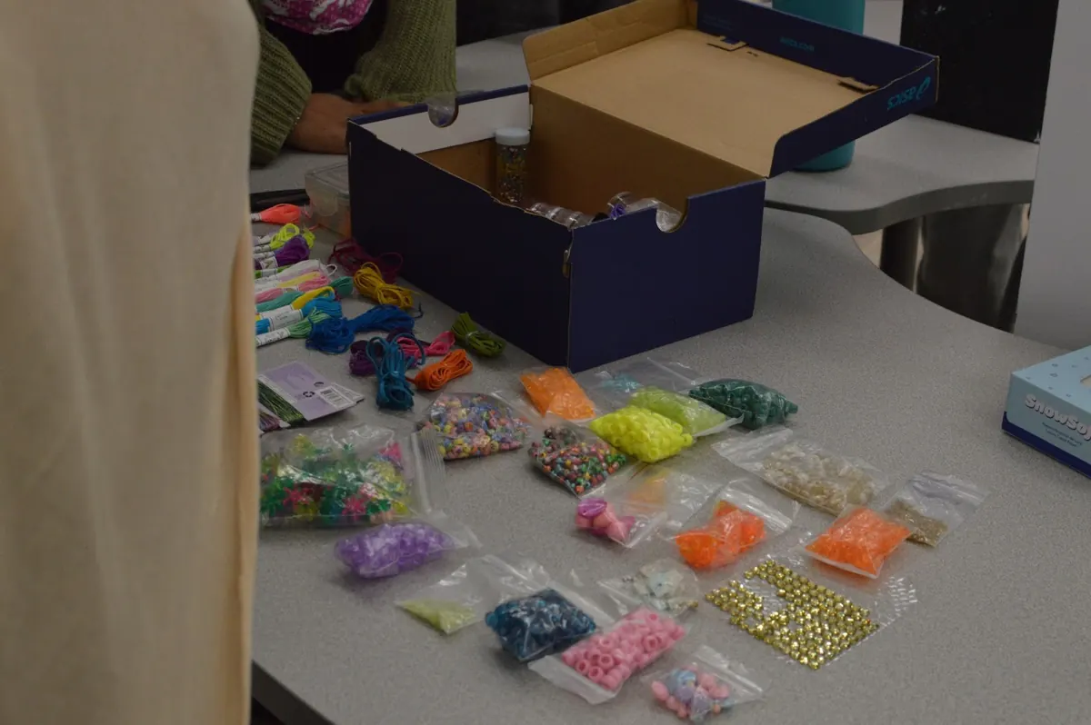Bags of colourful beads laid out for bracelet making